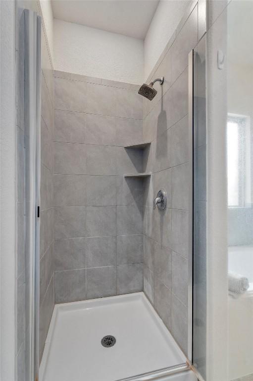 bathroom featuring a shower with shower door