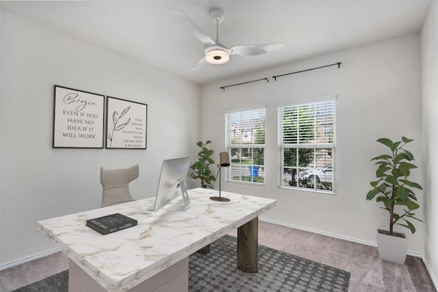 carpeted office space with ceiling fan