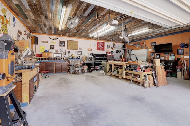 garage with a workshop area and a garage door opener