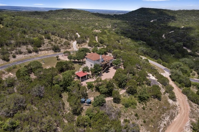 drone / aerial view with a wooded view