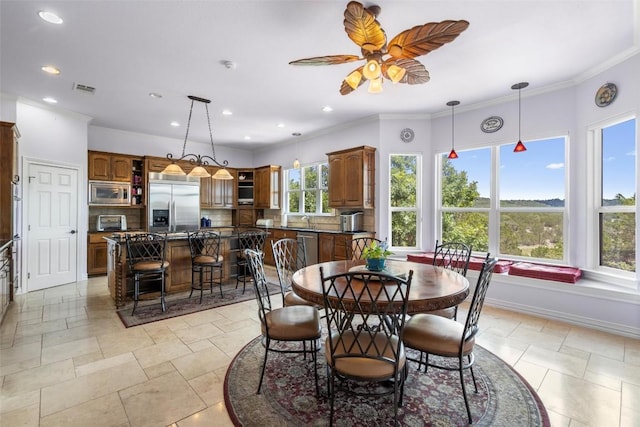 dining room featuring baseboards, visible vents, a toaster, recessed lighting, and crown molding