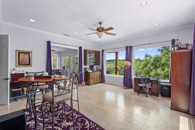 dining room with ceiling fan, ornamental molding, light tile patterned floors, and a healthy amount of sunlight