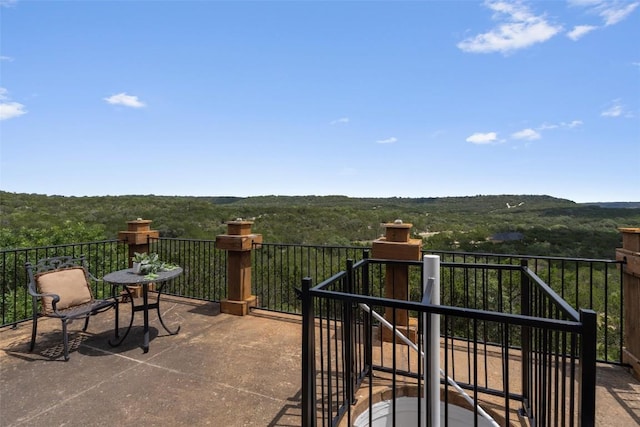 view of patio with a forest view