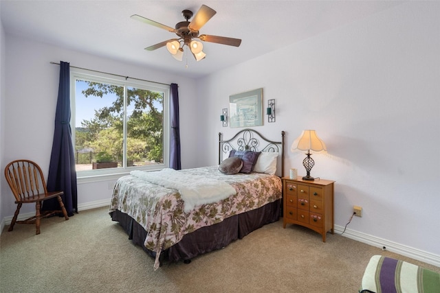 bedroom with ceiling fan and light carpet