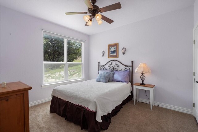 bedroom with ceiling fan and light colored carpet