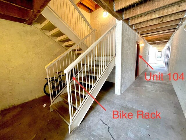 staircase featuring concrete flooring