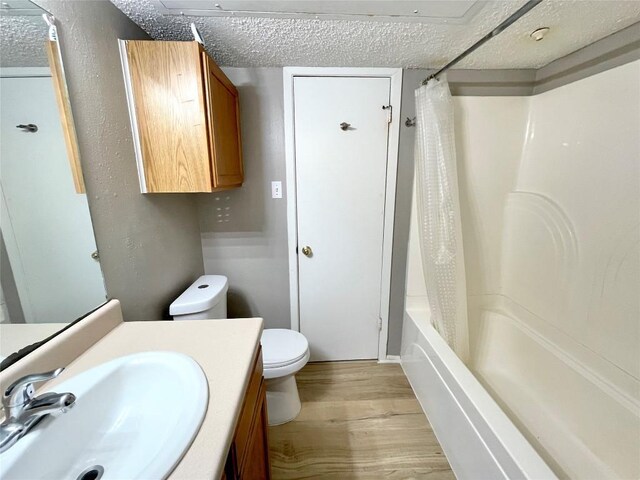 full bathroom featuring shower / bath combo with shower curtain, wood-type flooring, toilet, and vanity