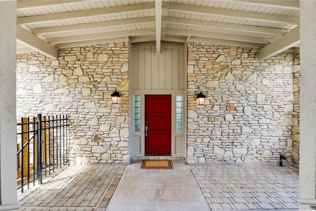 doorway to property featuring stone siding