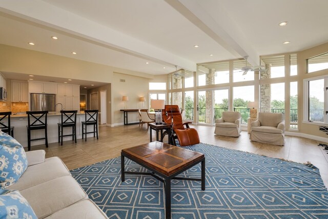 living room with beamed ceiling, recessed lighting, and baseboards