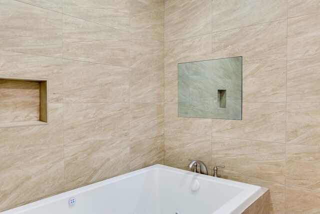 full bathroom with a tub to relax in and tile walls