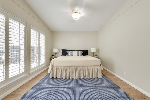 bedroom with baseboards and wood finished floors