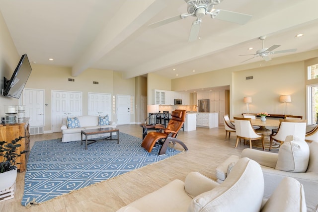 living area featuring visible vents, beam ceiling, and recessed lighting