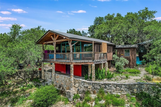 back of property featuring a wooden deck