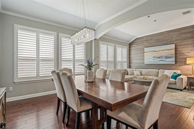 dining area featuring a wealth of natural light, crown molding, vaulted ceiling, and a notable chandelier