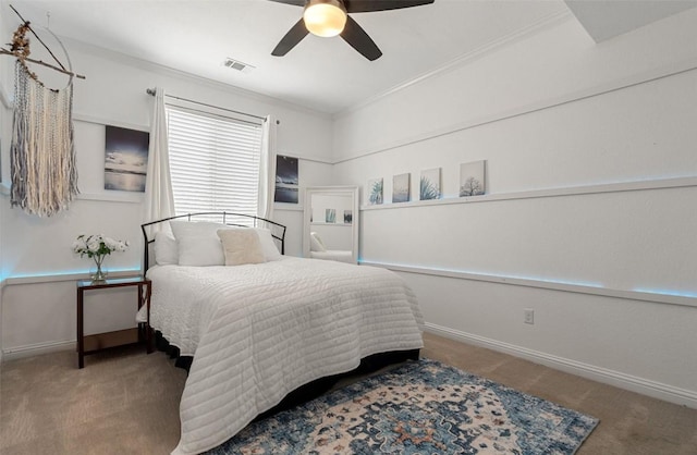 carpeted bedroom with ceiling fan and crown molding