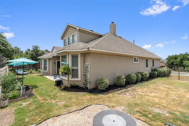 rear view of property featuring a yard