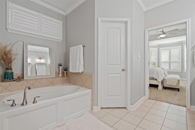 bathroom featuring tile patterned flooring, a bathing tub, ceiling fan, and crown molding