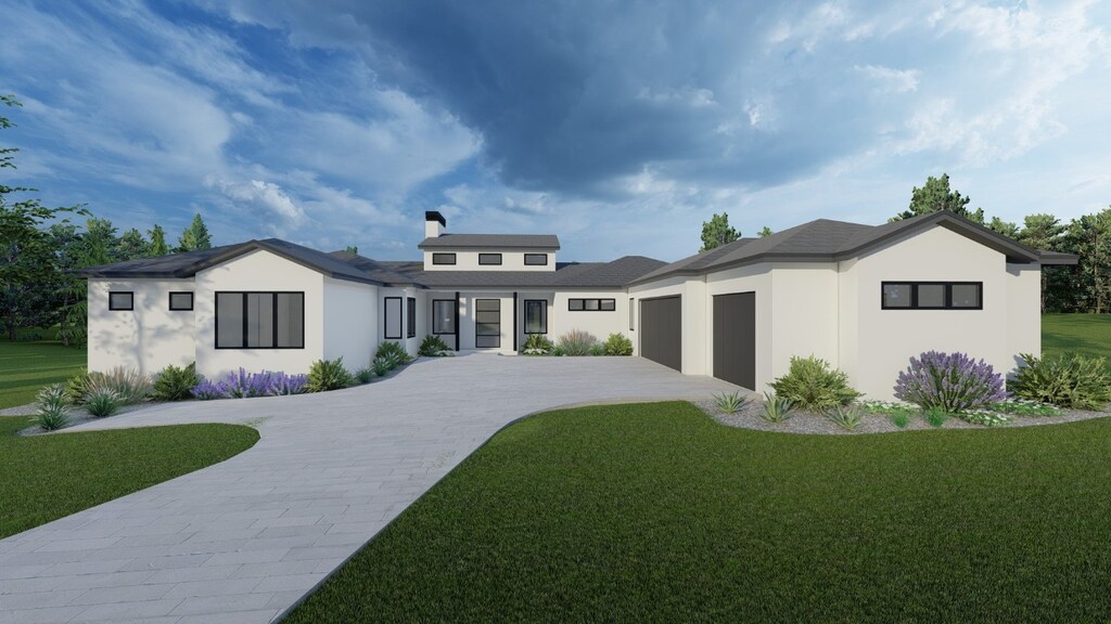 prairie-style home featuring a garage and a front lawn