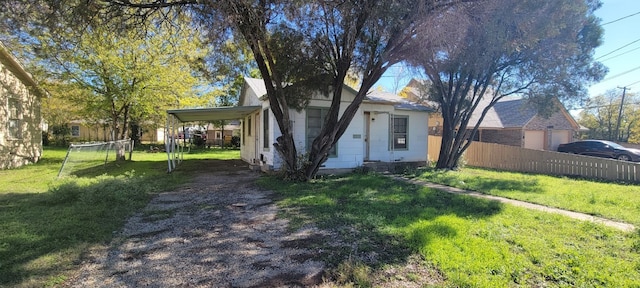 view of front of property with a carport and a front lawn