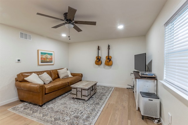 living room with hardwood / wood-style flooring and ceiling fan