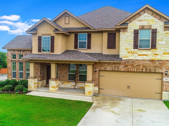 craftsman-style home with a garage and a front lawn