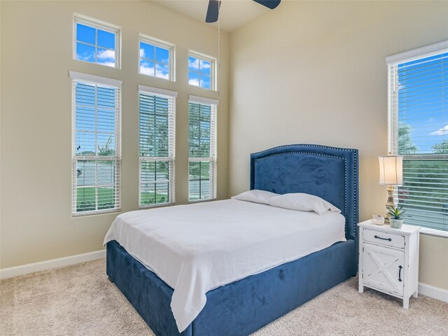 bedroom featuring light carpet and ceiling fan