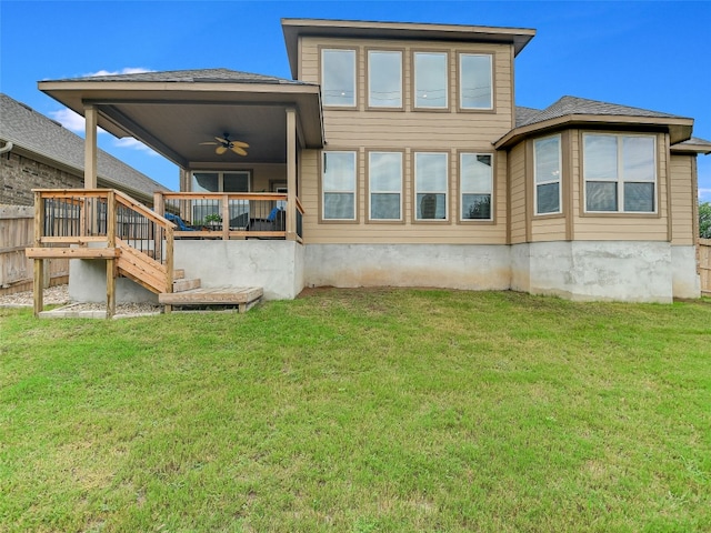 back of house with ceiling fan and a lawn