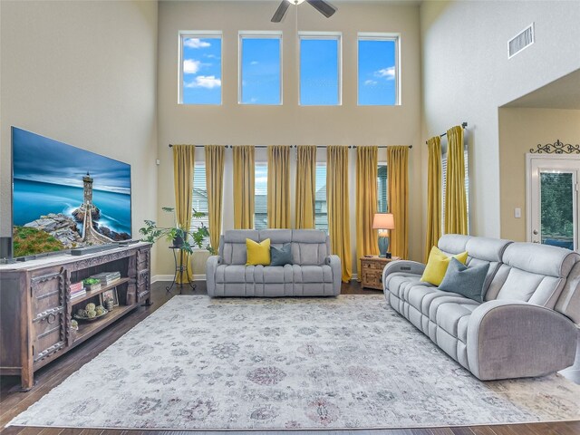 living room featuring ceiling fan, hardwood / wood-style flooring, and a healthy amount of sunlight