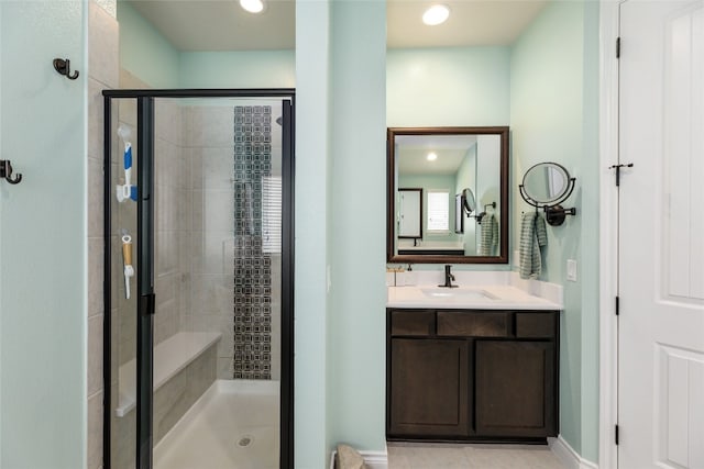 bathroom featuring vanity, tile patterned flooring, and walk in shower