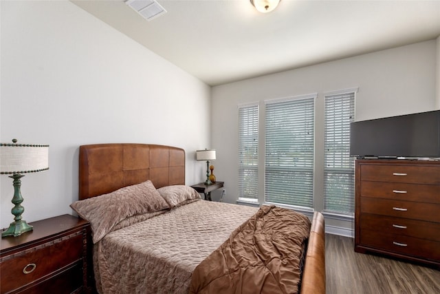 bedroom featuring dark hardwood / wood-style floors and lofted ceiling