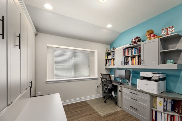 office featuring built in desk, dark wood-type flooring, and lofted ceiling