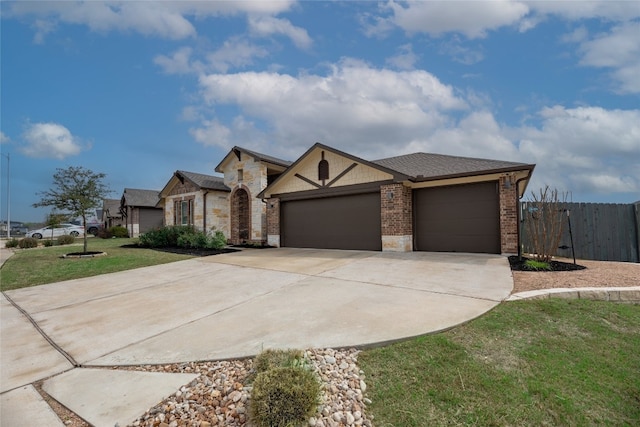 view of front of house with an attached garage, brick siding, fence, concrete driveway, and a front yard