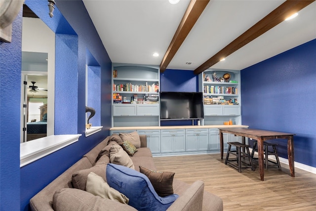 bar with ceiling fan, built in shelves, white cabinets, beam ceiling, and light hardwood / wood-style flooring