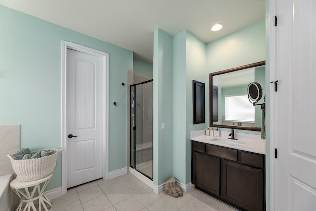 bathroom with tile patterned floors, vanity, and a shower with door