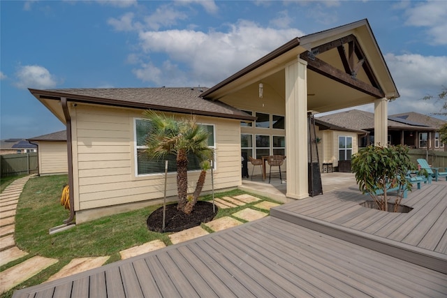 wooden deck featuring a lawn