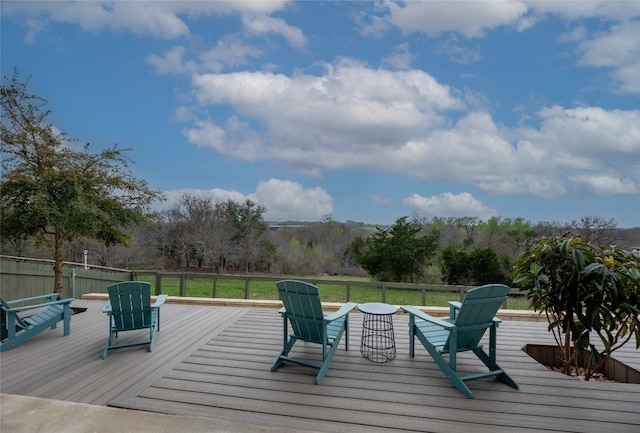 wooden deck featuring a lawn