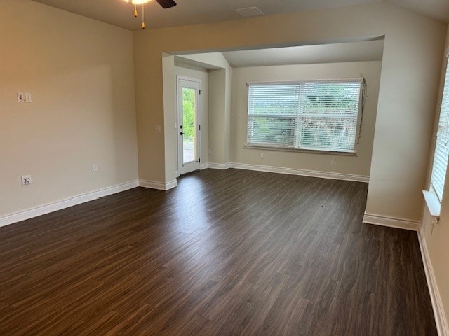 unfurnished room with dark wood-type flooring and ceiling fan