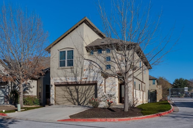 view of front facade featuring fence, concrete driveway, stucco siding, a garage, and stone siding