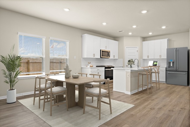 dining space featuring light hardwood / wood-style flooring and plenty of natural light