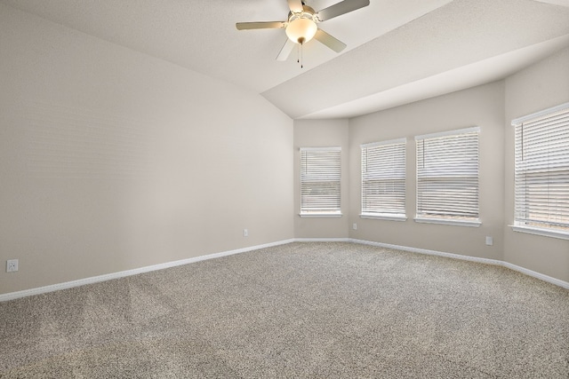 unfurnished room featuring ceiling fan, vaulted ceiling, and carpet