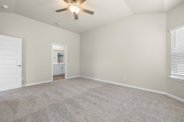 unfurnished bedroom featuring ceiling fan, carpet floors, and lofted ceiling