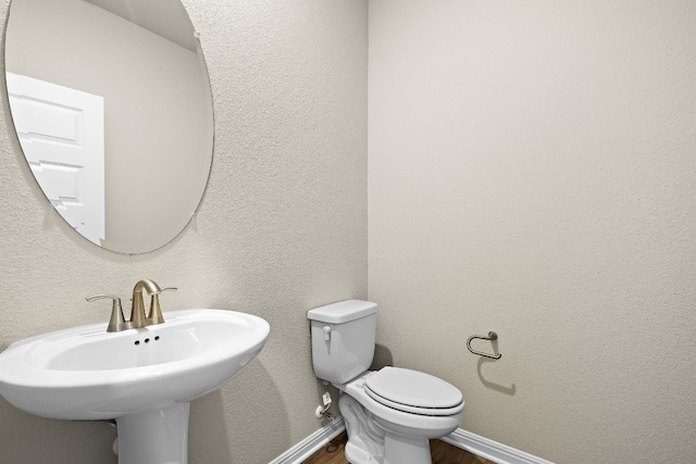 bathroom with wood-type flooring and toilet