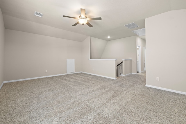 carpeted spare room with ceiling fan and lofted ceiling