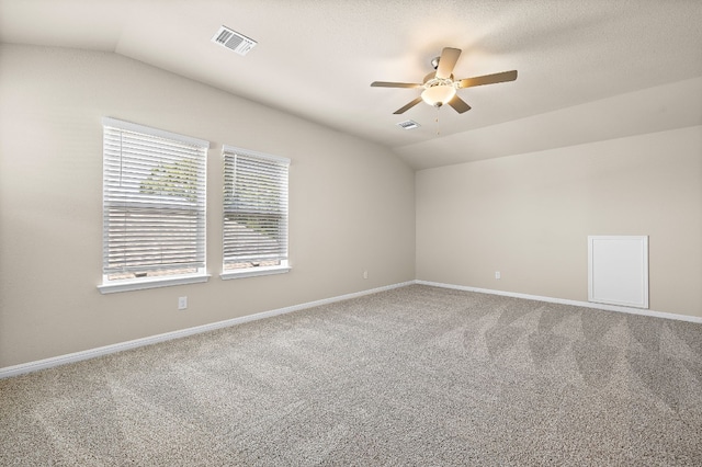 spare room featuring ceiling fan, carpet floors, and lofted ceiling