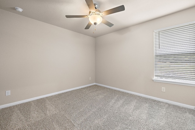 unfurnished room with ceiling fan, a healthy amount of sunlight, and carpet flooring