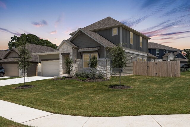 view of front of house featuring a lawn and a garage