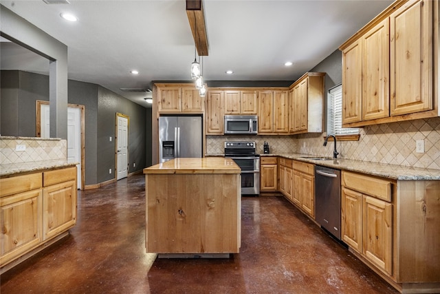 kitchen with sink, a kitchen island, appliances with stainless steel finishes, and backsplash