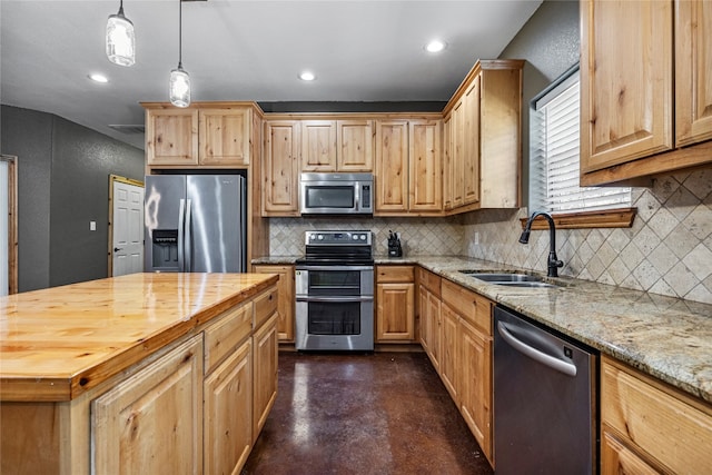 kitchen featuring stainless steel appliances, hanging light fixtures, decorative backsplash, sink, and wood counters