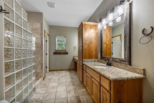 bathroom with vanity and tile patterned flooring