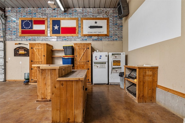 interior space featuring concrete floors and white fridge